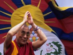 Далай-лама XIV и флаг Тибета. Фото: savetibet.org